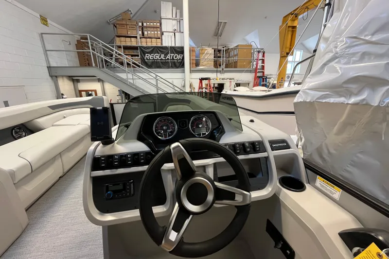 Slide: The Image of 2026 Godfrey Sweetwater 2286 MT boat interior with steering wheel and dashboard controls. - 12