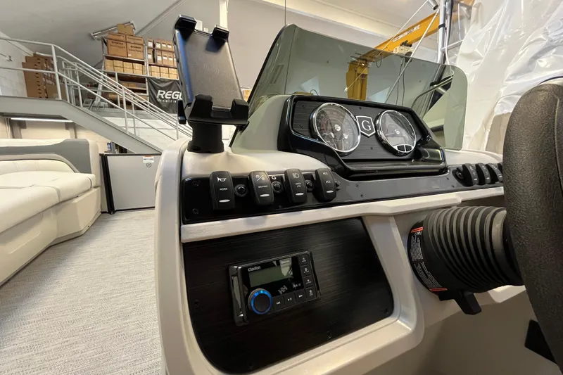 Slide: The Image of 2026 Godfrey Sweetwater 2286 MT boat dashboard with controls and gauges in showroom. - 14