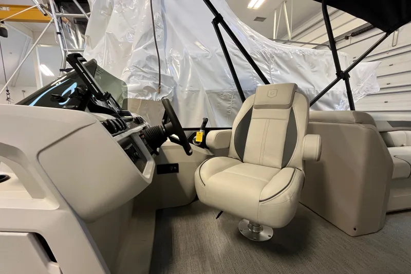 Slide: The Image of 2026 Godfrey Sweetwater 2286 MT boat interior with captain's chair and control panel. - 15