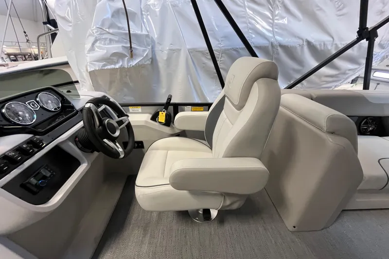 Slide: The Image of 2026 Godfrey Sweetwater 2286 MT boat interior with steering wheel and captain's chair. - 16