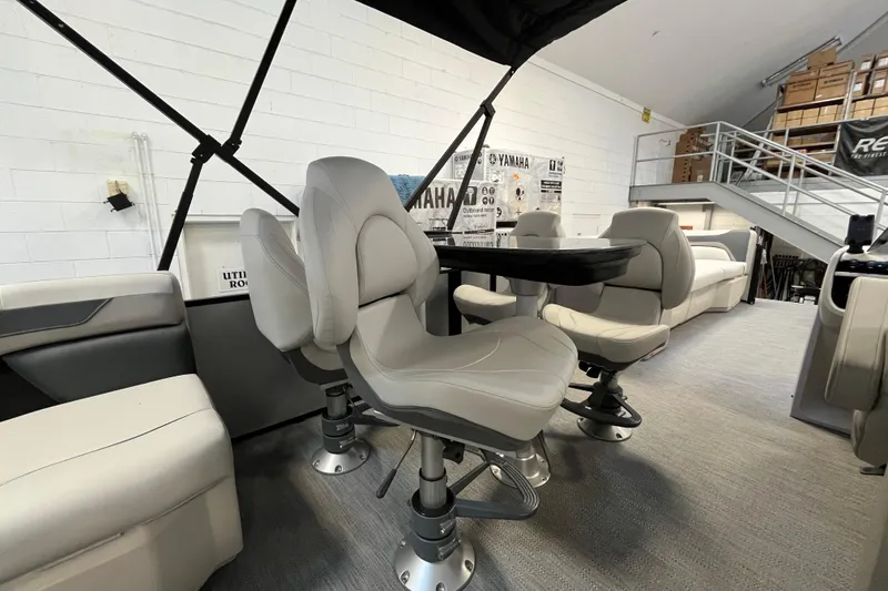 Slide: The Image of 2026 Godfrey Sweetwater 2286 MT interior with plush seating and table setup. - 22