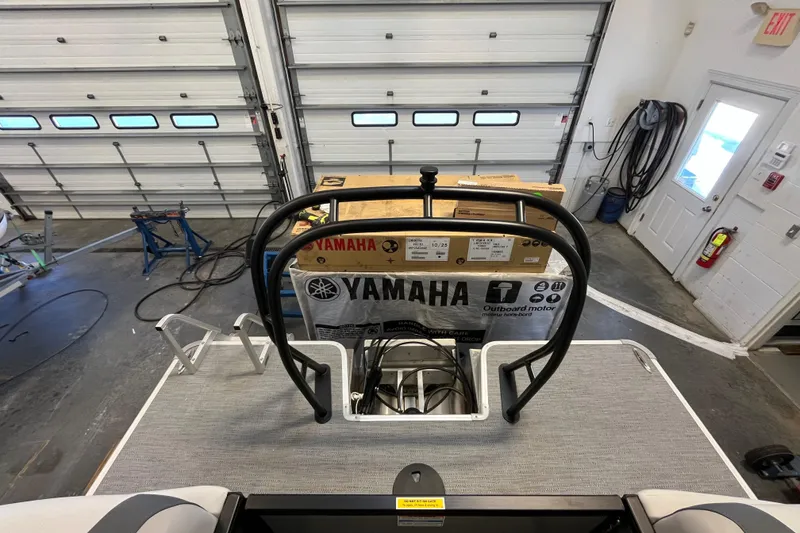 Slide: The Image of 2026 Godfrey Sweetwater 2286 MT pontoon boat in garage with Yamaha outboard motor box. - 24