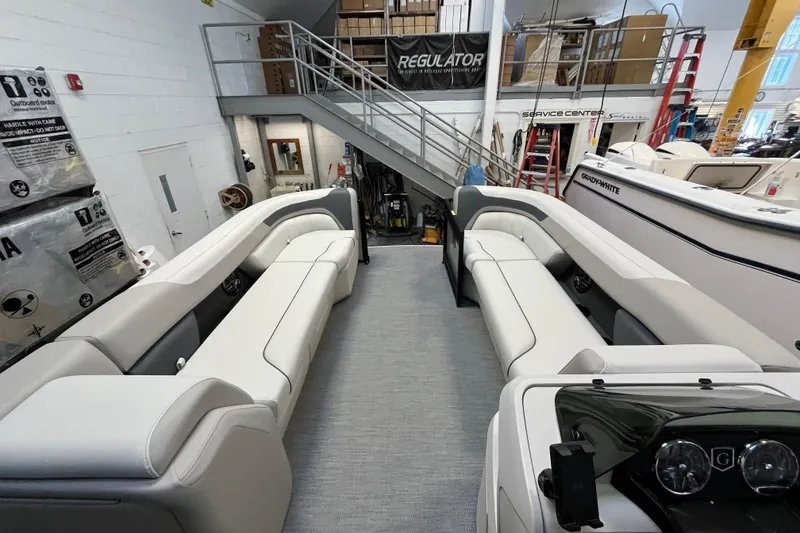 Slide: The Image of 2026 Godfrey Sweetwater 2286 MT pontoon boat interior with plush seating in showroom. - 26