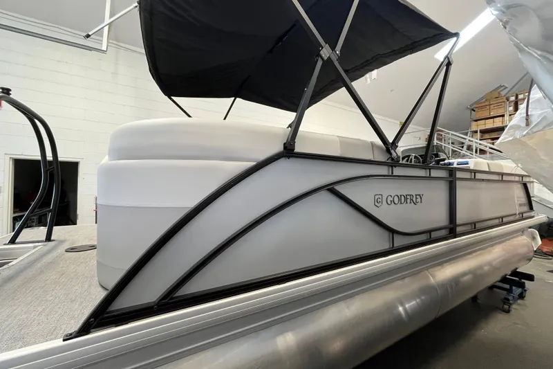 Slide: The Image of 2026 Godfrey Sweetwater 2286 MT pontoon boat with canopy in indoor storage. - 8