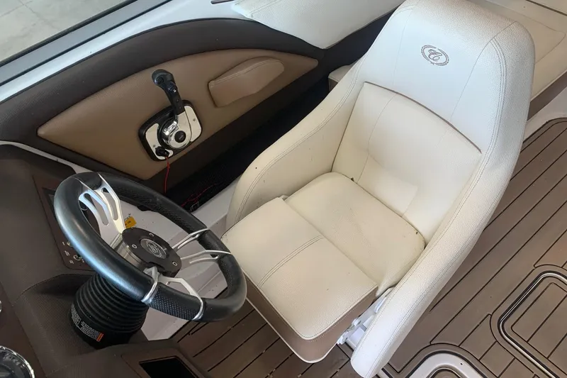 Slide: The Image of Steering wheel and seat of 2017 Cobalt 220S boat interior. - 13