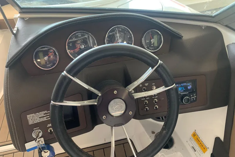 Slide: The Image of Dashboard of a 2017 Cobalt 220S boat with steering wheel and gauges. - 15