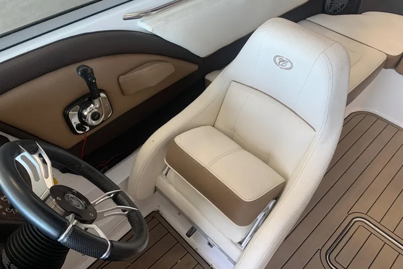 Slide: The Image of 2017 Cobalt 220S boat interior with steering wheel and white captain's chair. - 17