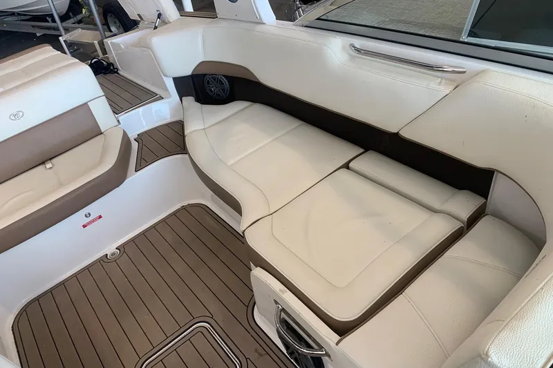 Slide: The Image of Luxurious interior seating of a 2017 Cobalt 220S boat with white and tan upholstery. - 18