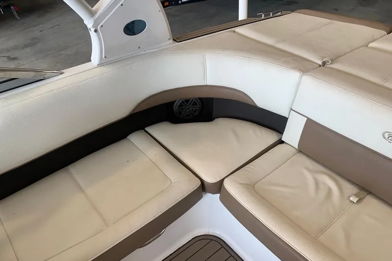 Slide: The Image of Luxurious seating area in a 2017 Cobalt 220S boat, featuring beige and brown upholstery. - 19
