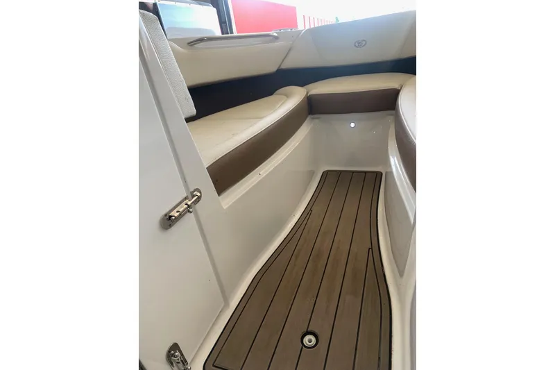 Slide: The Image of Interior view of a 2017 Cobalt 220S boat, featuring sleek seating and wood-style flooring. - 20