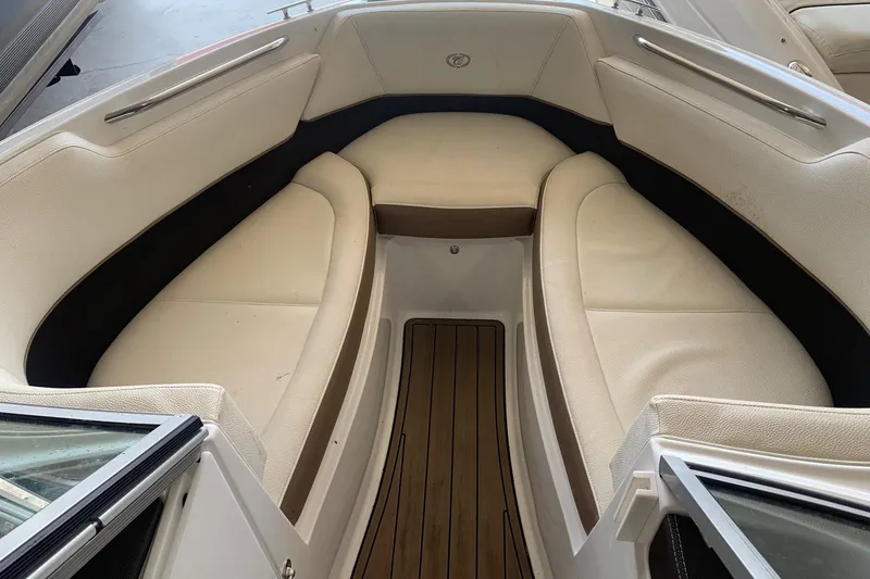Slide: The Image of Interior view of a 2017 Cobalt 220S boat with beige seating and wooden flooring. - 22