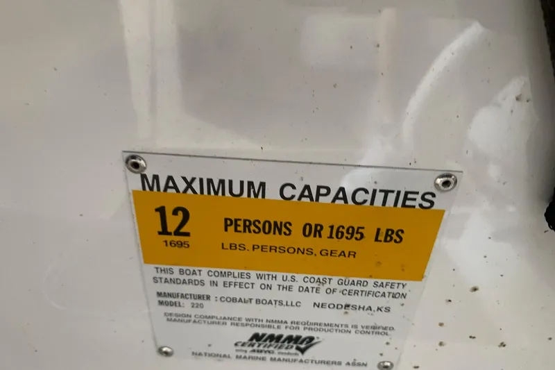 Slide: The Image of Capacity label on 2017 Cobalt 220S boat: 12 persons or 1695 lbs maximum. - 29