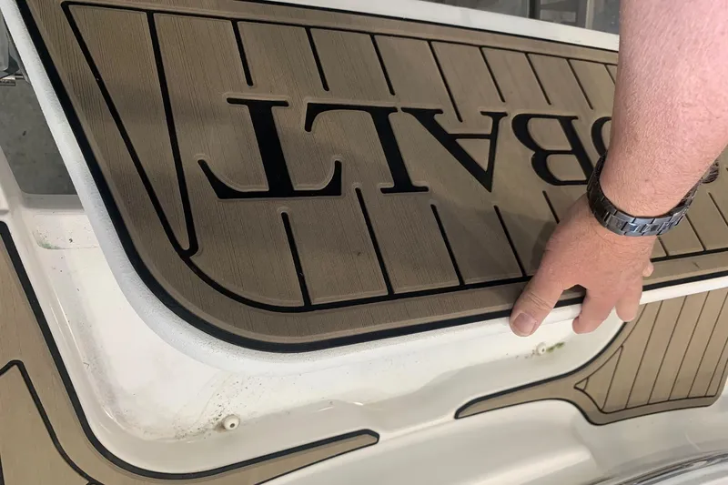 Slide: The Image of Hand adjusting Cobalt 220S boat flooring, 2017 model. - 31