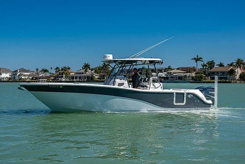 The Image of 2018 Sea Fox 328 Commander boat cruising on calm waters near waterfront homes. - 1