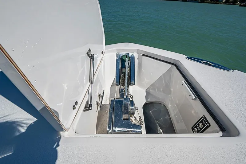 Slide: The Image of Open anchor compartment on 2018 Sea Fox 328 Commander boat, showing winch and hardware. - 11