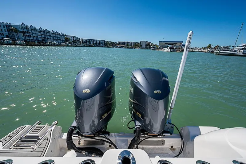 Slide: The Image of 2018 Sea Fox 328 Commander with dual Yamaha V8 engines on a sunny waterfront. - 23