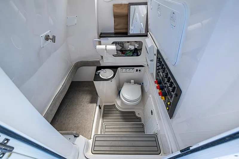 Slide: The Image of Interior of 2018 Sea Fox 328 Commander boat bathroom with toilet and control panel. - 25