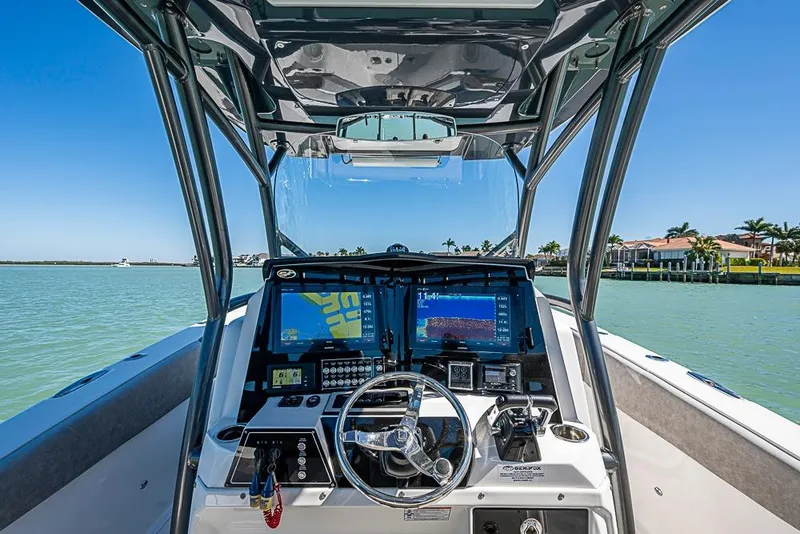 Slide: The Image of 2018 Sea Fox 328 Commander boat dashboard with navigation screens on a sunny day. - 27