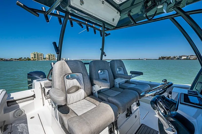 Slide: The Image of 2018 Sea Fox 328 Commander boat interior with plush seating and scenic water view. - 29