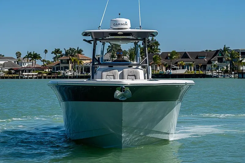 Slide: The Image of 2018 Sea Fox 328 Commander boat cruising on calm waters near waterfront homes. - 3