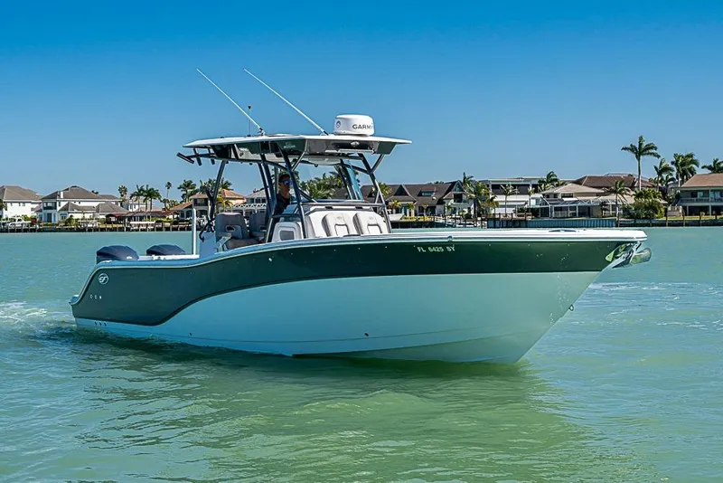 Slide: The Image of 2018 Sea Fox 328 Commander boat cruising on calm waters near coastal homes. - 4