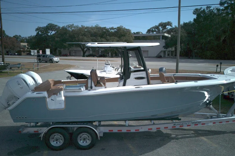 Slide: The Image of 2026 Sea Hunt Ultra 275 SE boat on trailer, parked outdoors. - 11