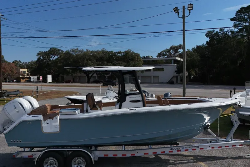 Slide: The Image of 2026 Sea Hunt Ultra 275 SE boat on trailer, parked outdoors. - 12