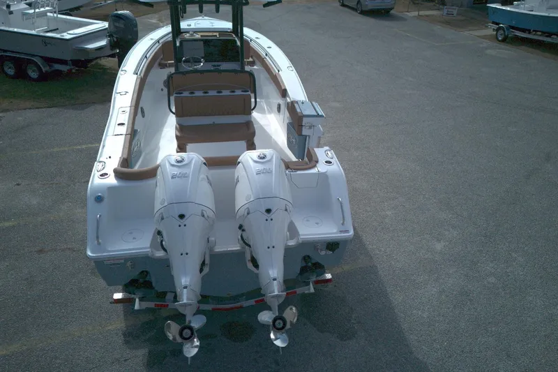 Slide: The Image of 2026 Sea Hunt Ultra 275 SE boat with dual outboard engines, viewed from the rear. - 3
