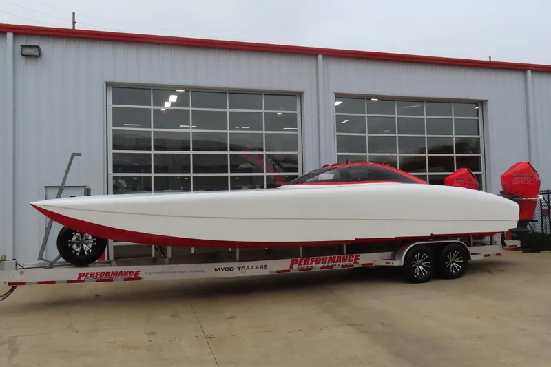 The Image of 2019 Wright Performance 320 Race boat on trailer outside garage. - 0