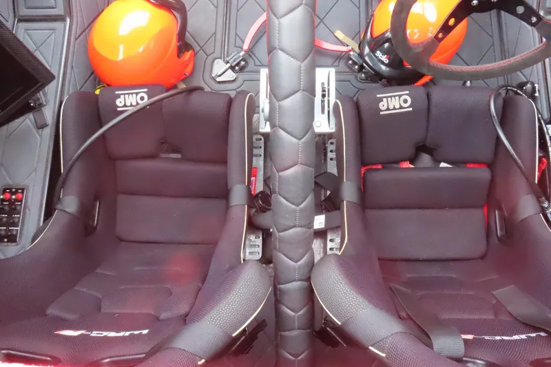 Slide: The Image of Interior of 2019 Wright Performance 320 Race car with racing seats and helmets. - 29
