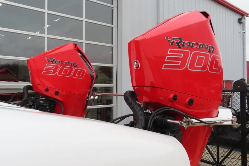 Slide: The Image of Red Wright Performance 320 Race 2019 outboard motors, labeled "Racing 300," near a garage. - 4