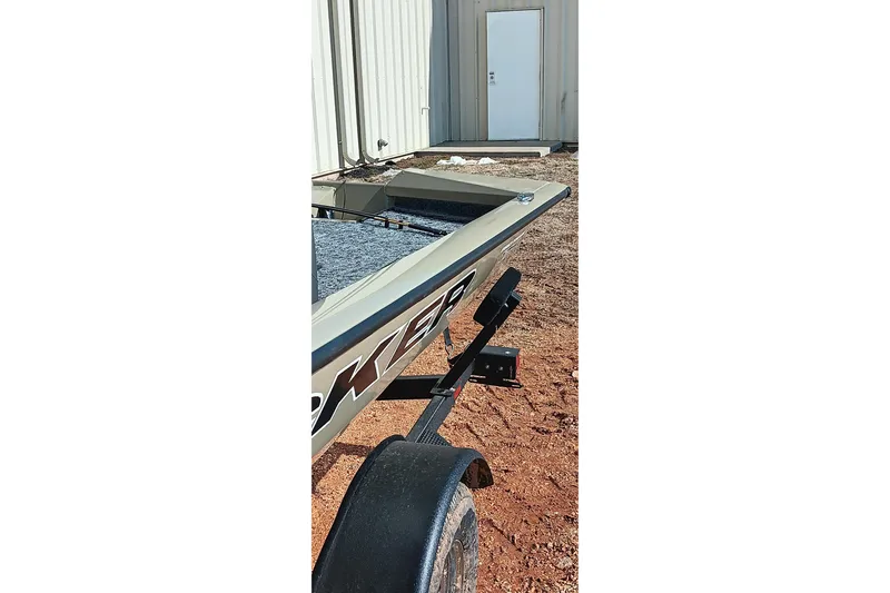 Slide: The Image of 2026 Tracker Pro Team 175 boat on trailer near a building. - 15