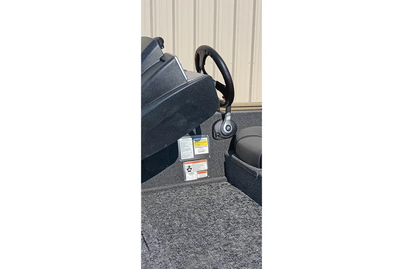 Slide: The Image of Interior view of 2026 Tracker Pro Team 175 boat, featuring steering wheel and control panel. - 17