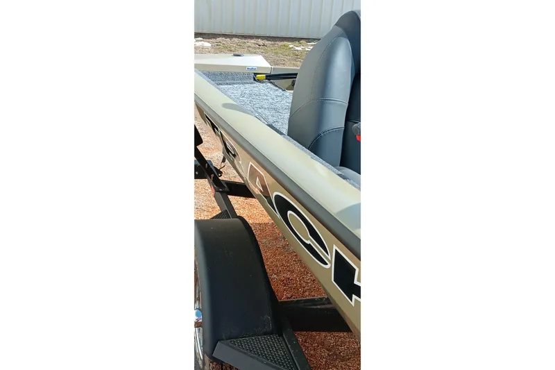 Slide: The Image of 2026 Tracker Pro Team 175 boat, side view with seating and trailer visible. - 21