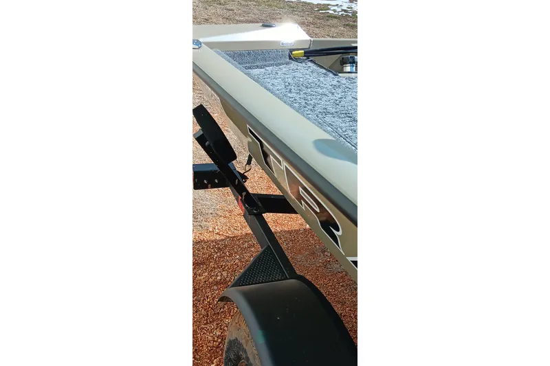 Slide: The Image of 2026 Tracker Pro Team 175 boat on trailer, side view with textured surface. - 22