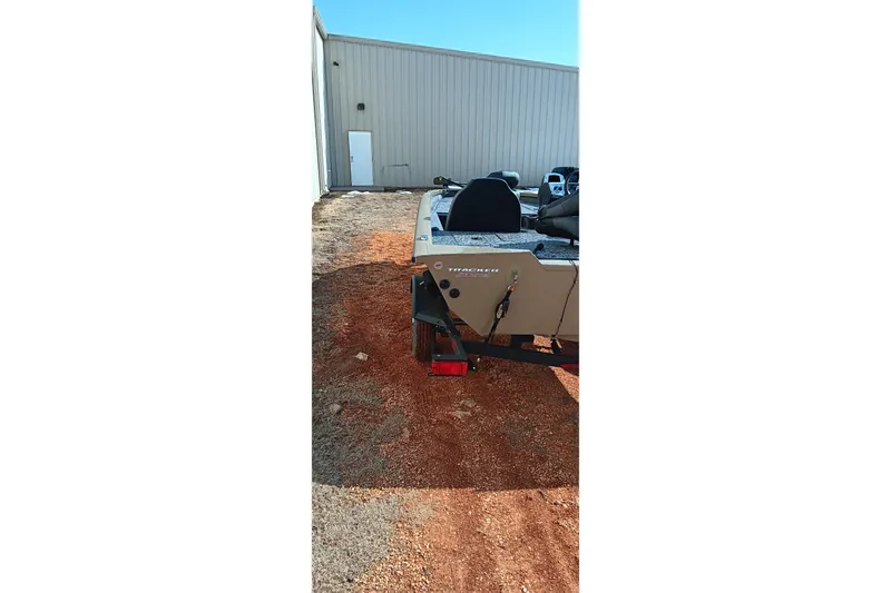 Slide: The Image of 2026 Tracker Pro Team 175 boat parked outside a metal building. - 4