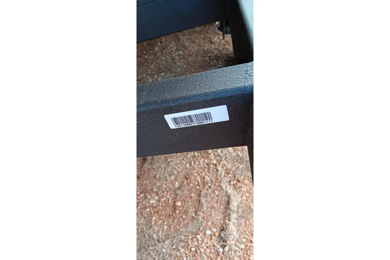 Slide: The Image of Barcode on Tracker Savage 215, 2026 model, against a textured metal surface. - 12