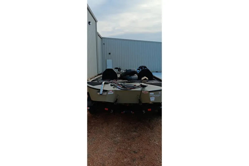 Slide: The Image of 2026 Tracker Savage 215 boat parked outside a metal building. - 13