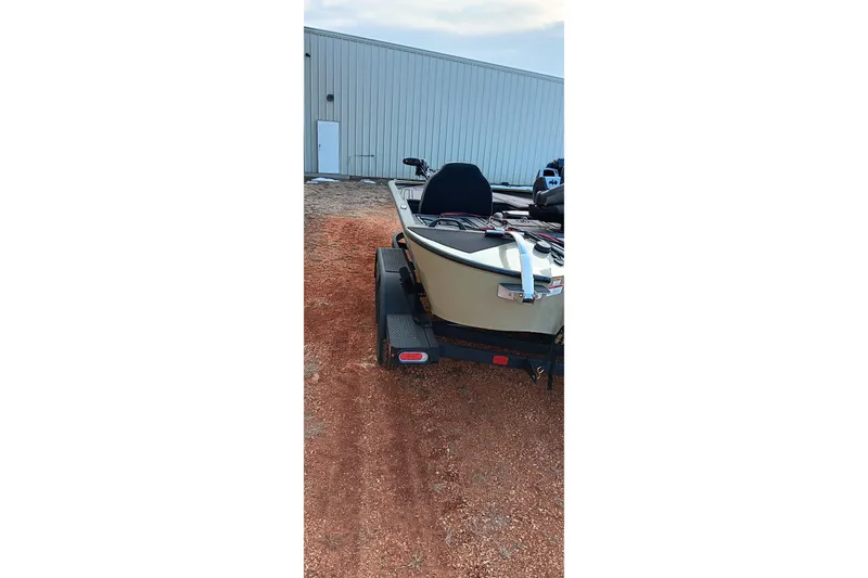 Slide: The Image of 2026 Tracker Savage 215 boat on trailer near metal building. - 14