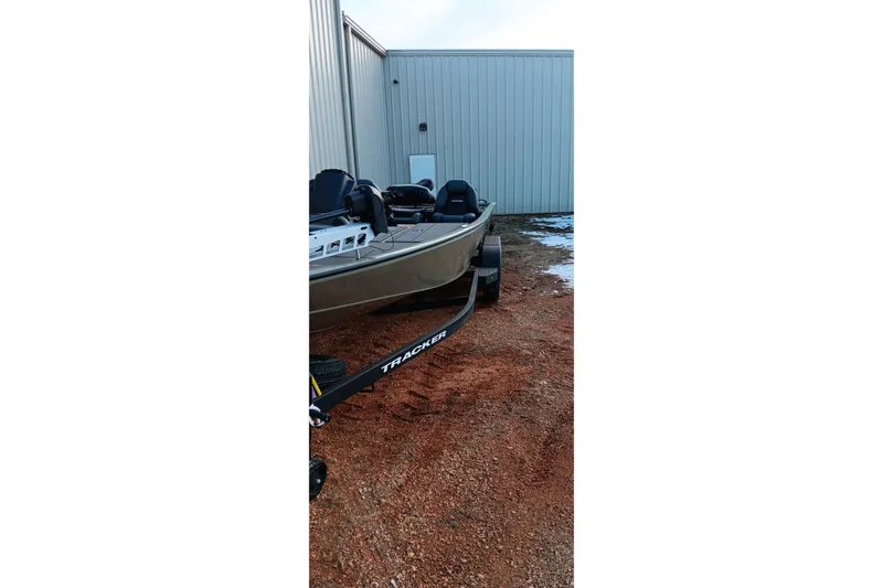 Slide: The Image of 2026 Tracker Savage 215 boat on trailer, parked outside metal building. - 5