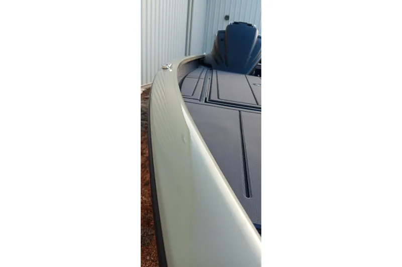 Slide: The Image of 2026 Tracker Savage 215 boat, sleek design, close-up view of deck and hull. - 8