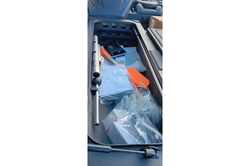 Slide: The Image of Storage compartment of 2026 Tracker Savage 215 boat with various equipment and accessories. - 9