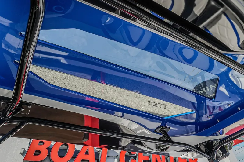 Slide: The Image of 2024 Renegade 38 Open boat, blue hull, displayed at a boat center. - 11