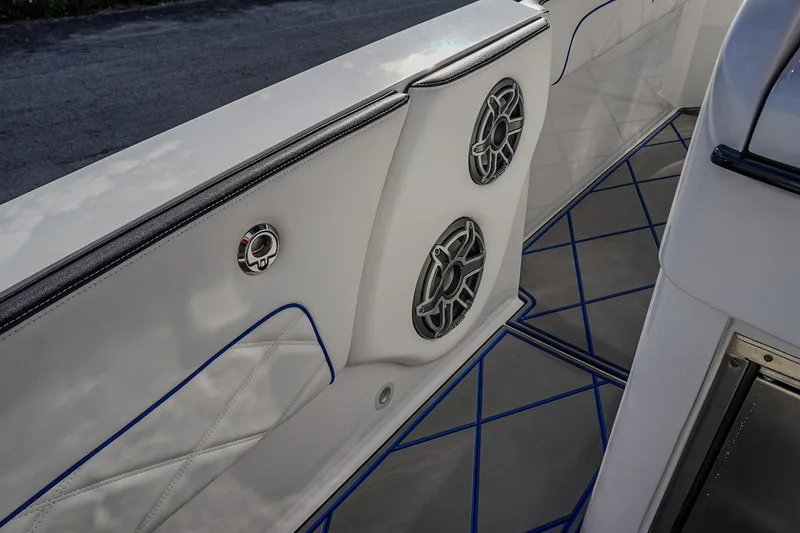 Slide: The Image of 2024 Renegade 38 Open boat interior with speakers and stylish blue-accented flooring. - 15