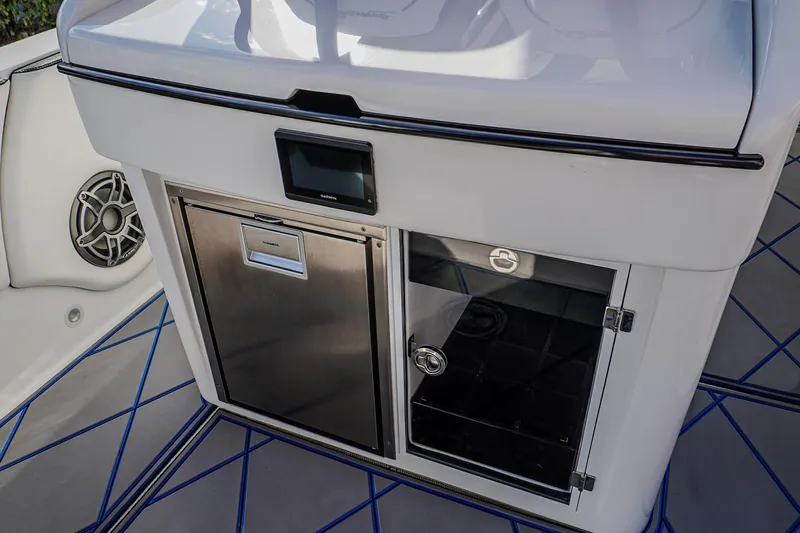 Slide: The Image of 2024 Renegade 38 Open boat interior with stainless steel fridge and storage compartment. - 20