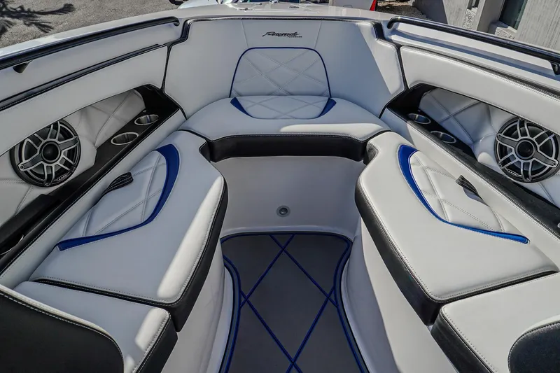 Slide: The Image of 2024 Renegade 38 Open boat interior with white and blue seating, speakers, and cup holders. - 23