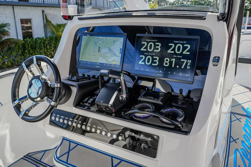 Slide: The Image of 2024 Renegade 38 Open boat dashboard with navigation screens and controls. - 30