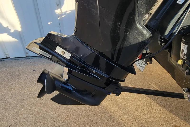 Slide: The Image of Bass Tracker Pro 16 2018 outboard motor, black finish, parked on concrete surface. - 10