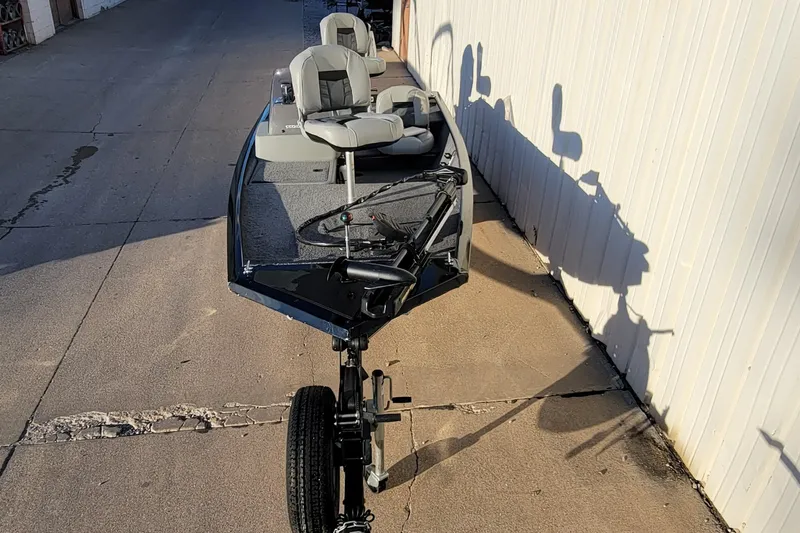 Slide: The Image of 2018 Bass Tracker Pro 16 fishing boat parked on concrete driveway. - 27