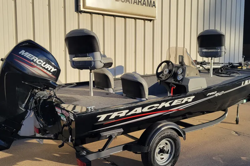 Slide: The Image of 2018 Bass Tracker Pro 16 fishing boat with Mercury outboard motor, parked outside. - 31